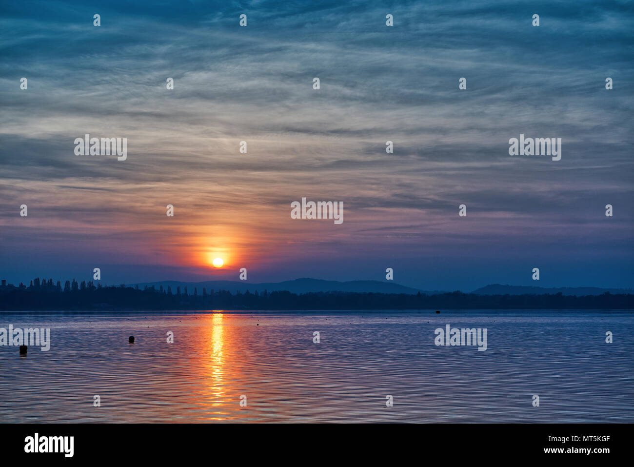 Ottimo tramonto sul lago di Varese nella stagione autunnale con incredibile cielo molto nuvoloso Foto Stock