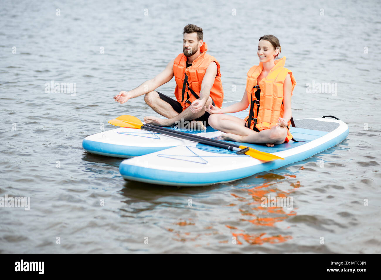 Giovane rilassante per lo stand up paddleboard Foto Stock