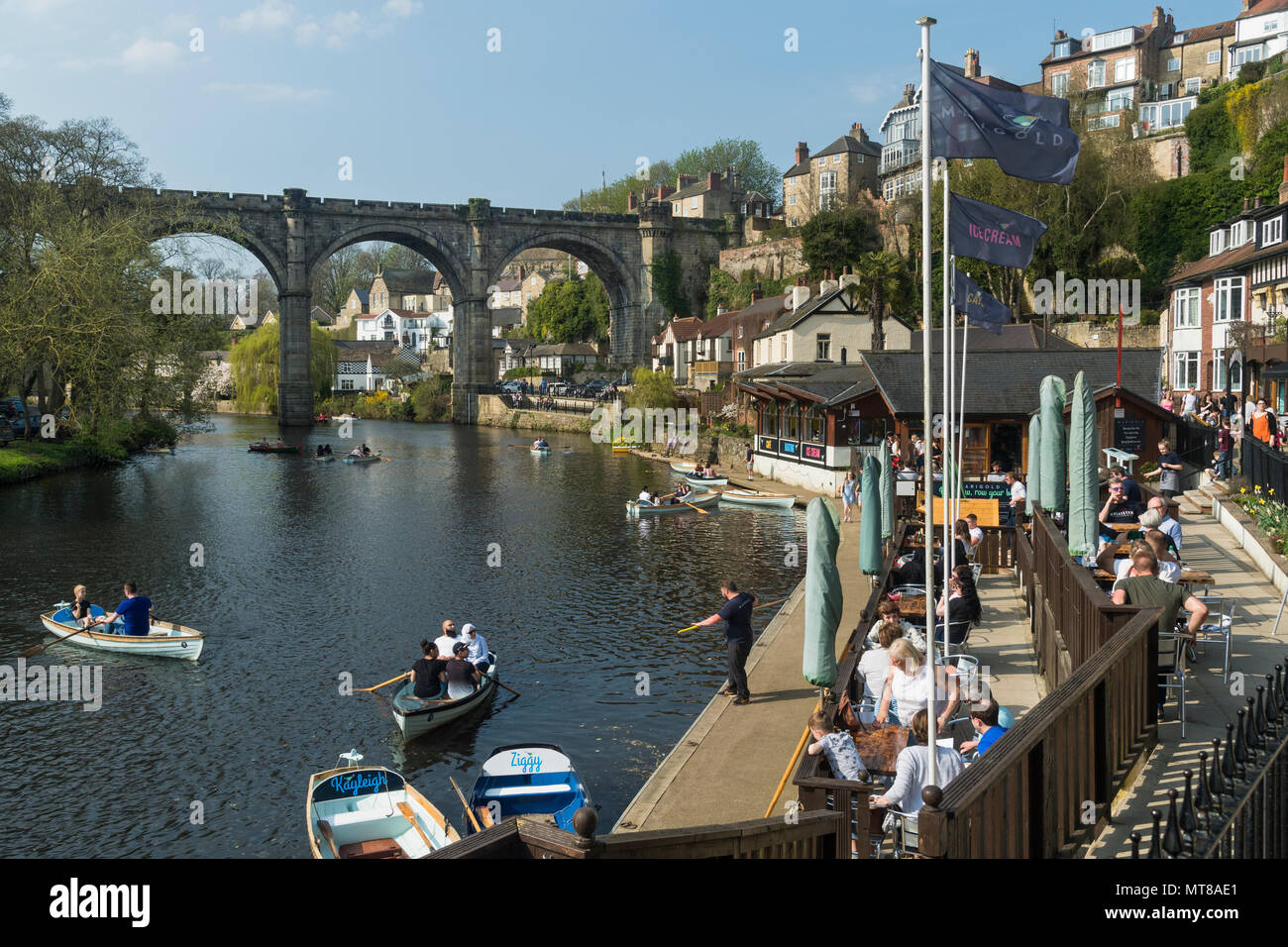Blue sky & persone rilassante da ponte a riverside cafe & barca a remi sul fiume Nidd - scenic soleggiata giornata estiva, Knaresborough, Inghilterra, Regno Unito. Foto Stock