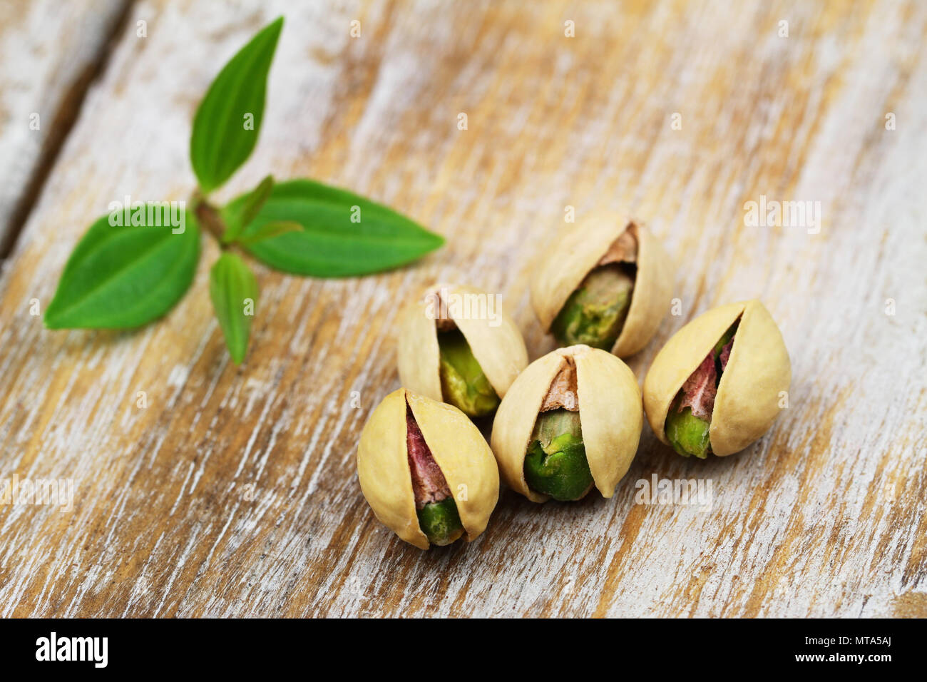 Cinque i pistacchi rustico superficie in legno Foto Stock