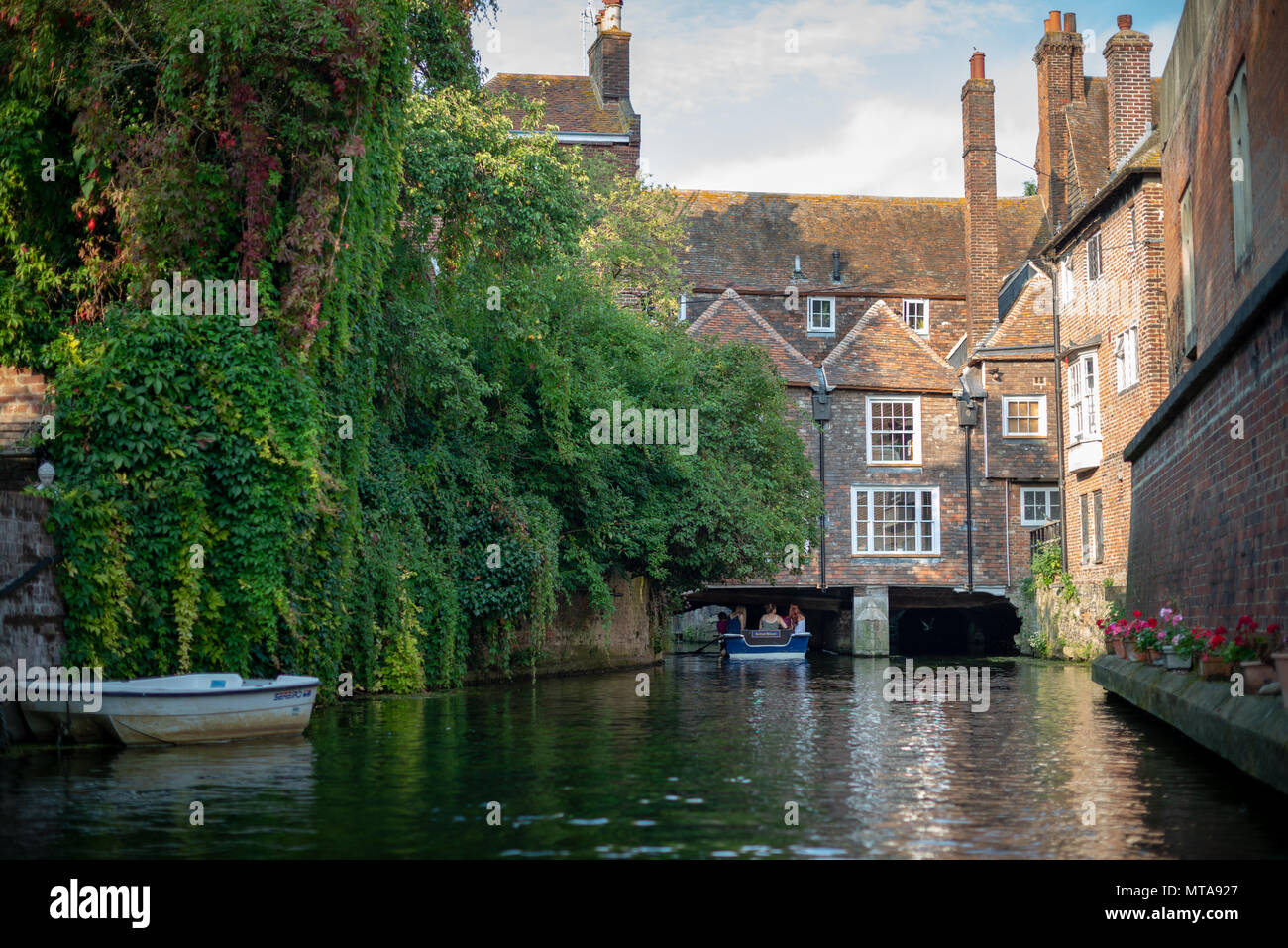 I turisti sulle rive di un fiume punt viaggio sul grande fiume Stour a Canterbury, Kent, Regno Unito. Foto Stock
