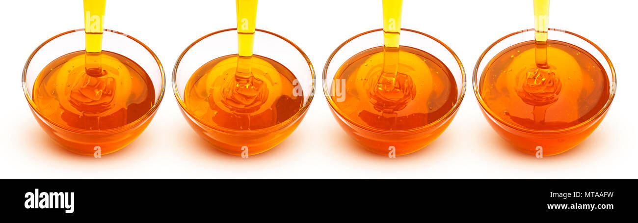 Versando il miele isolati su sfondo bianco Foto Stock