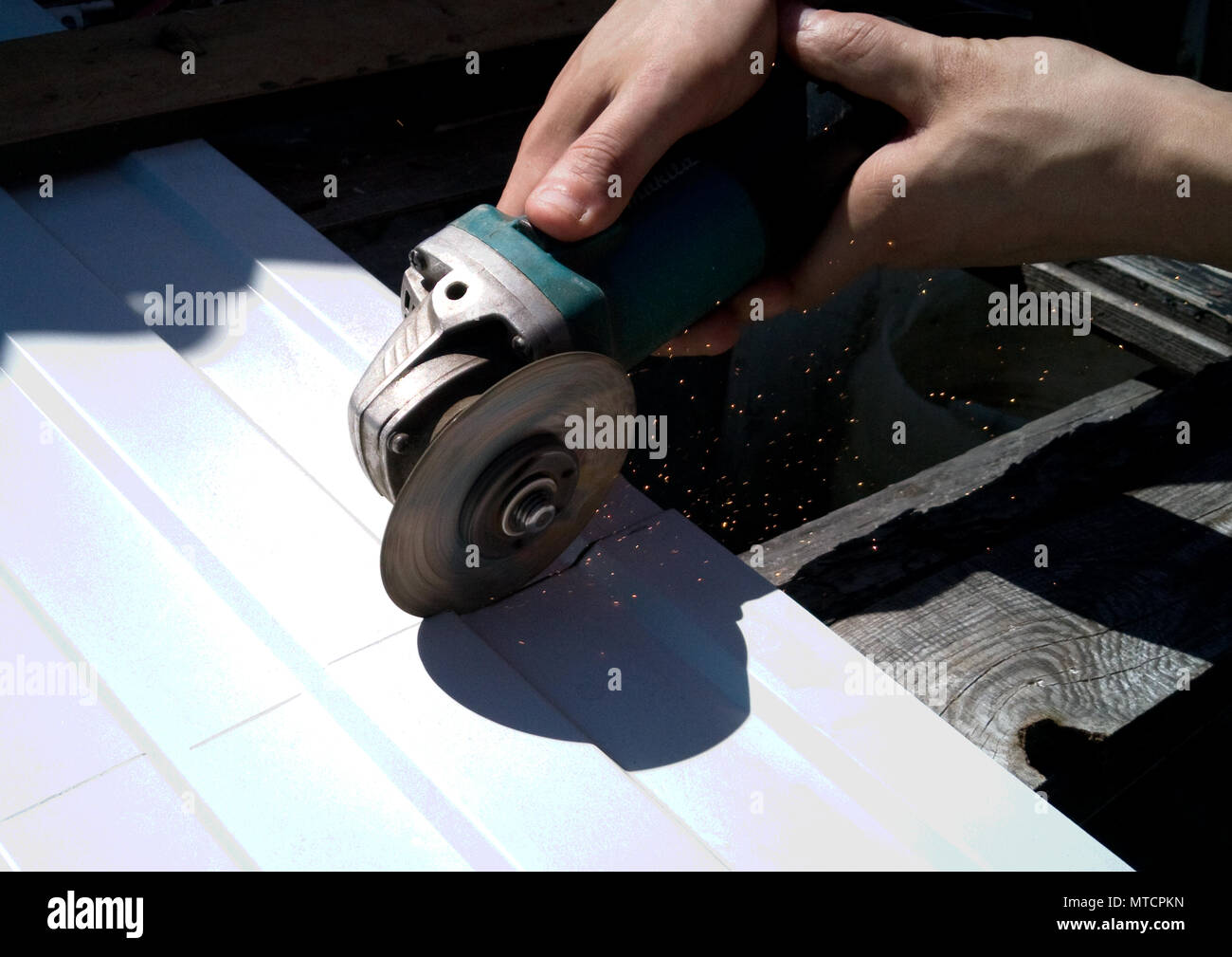 La formazione di scintille dalla sega circolare. Il taglio di metallo con un attrezzo speciale. Foto Stock