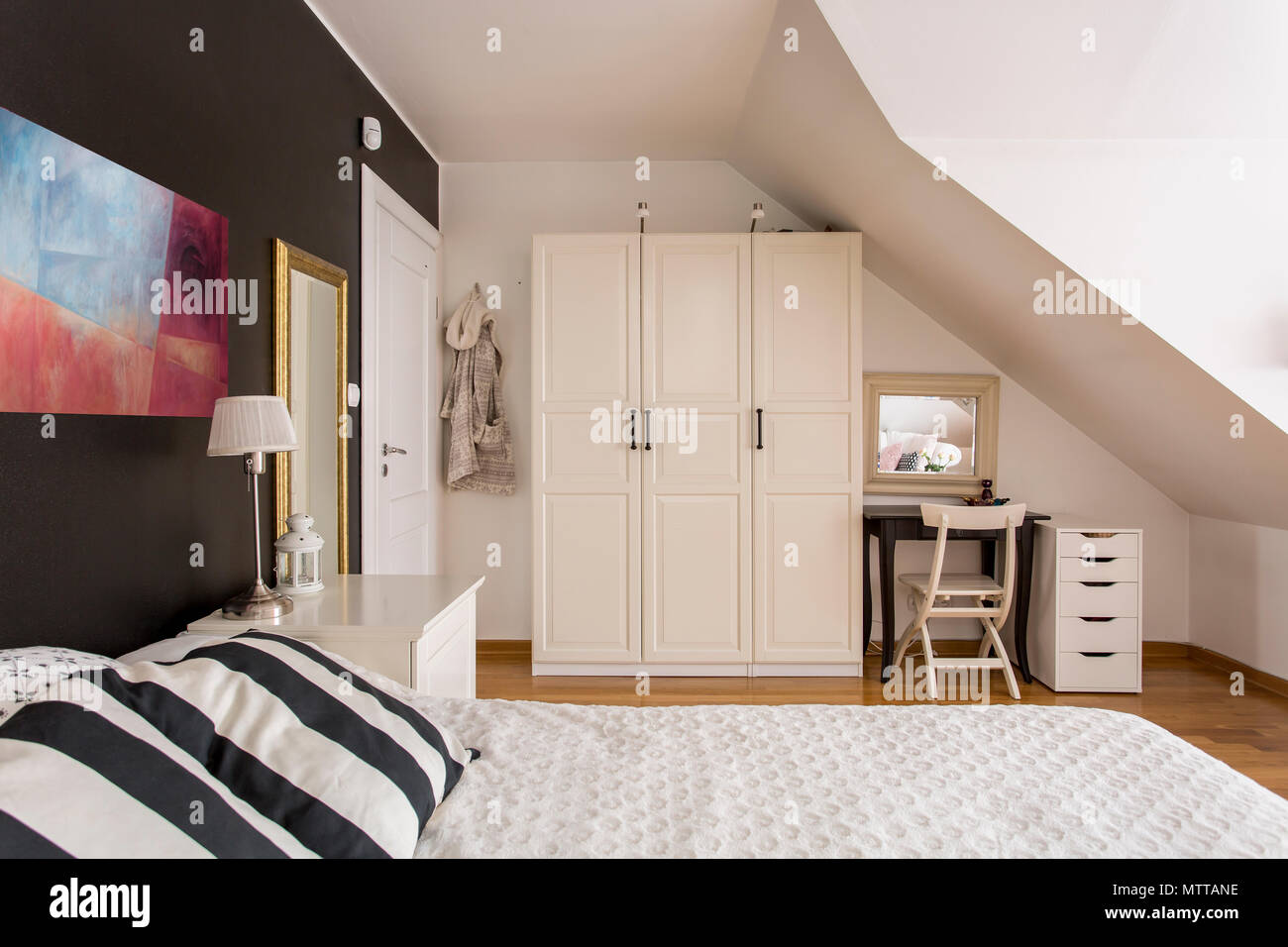 Nuovo stile mansarda camera da letto in bianco e nero con grande letto e mobili semplici Foto Stock