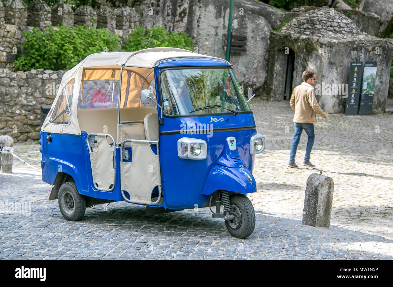 Blue tuk-tuk taxi vicino all'ingresso al castello moresco di Sintra, Portogallo. Foto Stock