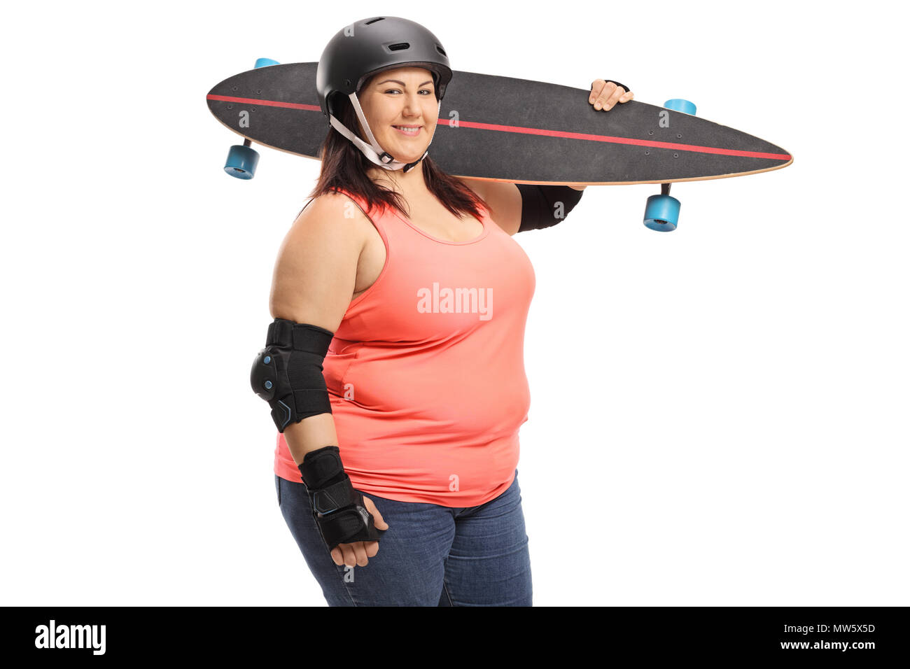 Il sovrappeso donna con un longboard e attrezzature di protezione guardando la telecamera e sorridente isolati su sfondo bianco Foto Stock