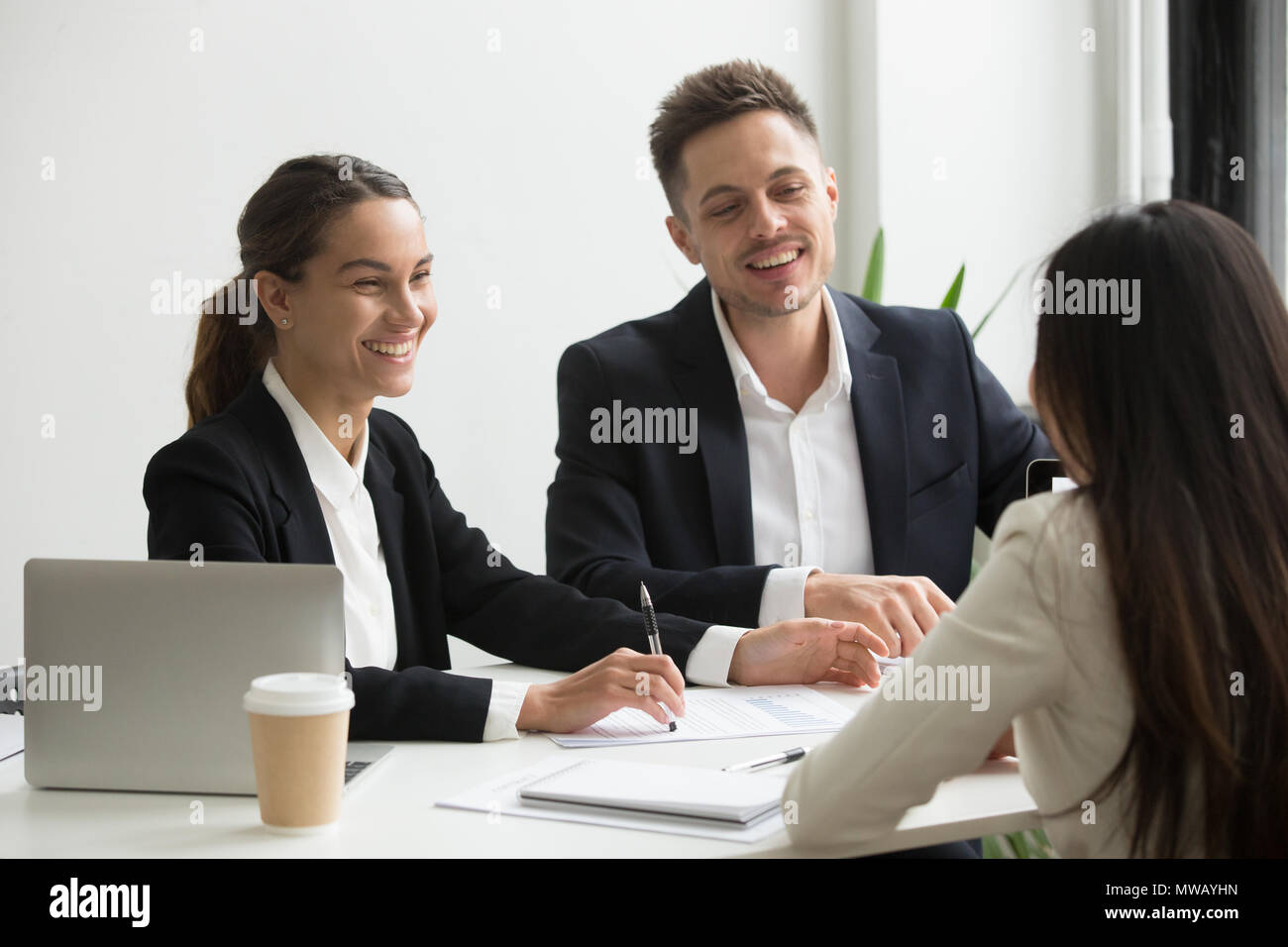 Gentili Membri del team chat ridere insieme durante l'ufficio b Foto Stock