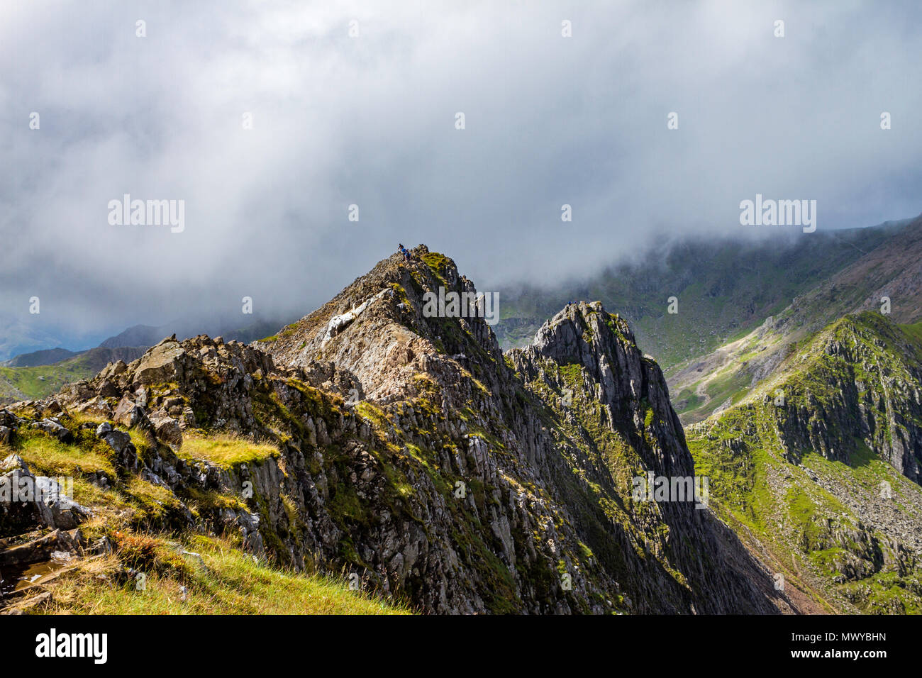 Affrontare il presepe precario Goch ridge sulla strada per la cima di Mount Snowdon, il picco più alto in Galles. Poco nuvoloso con il sole attraverso la rottura. Foto Stock