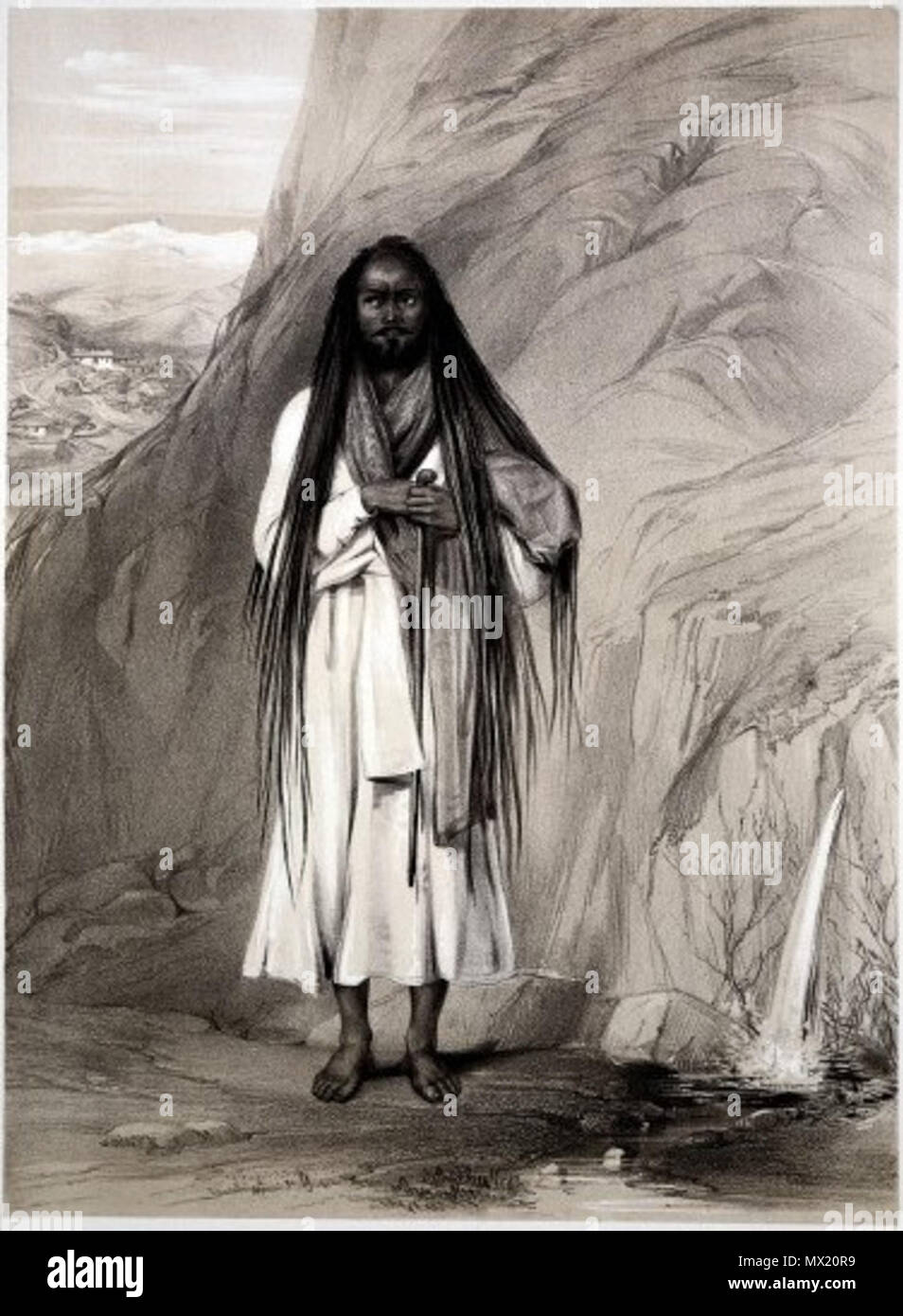 L0021806 un hindoo fakeer con capelli lunghi, mantello e bastone 20 un hindoo fakeer con capelli lunghi Foto Stock