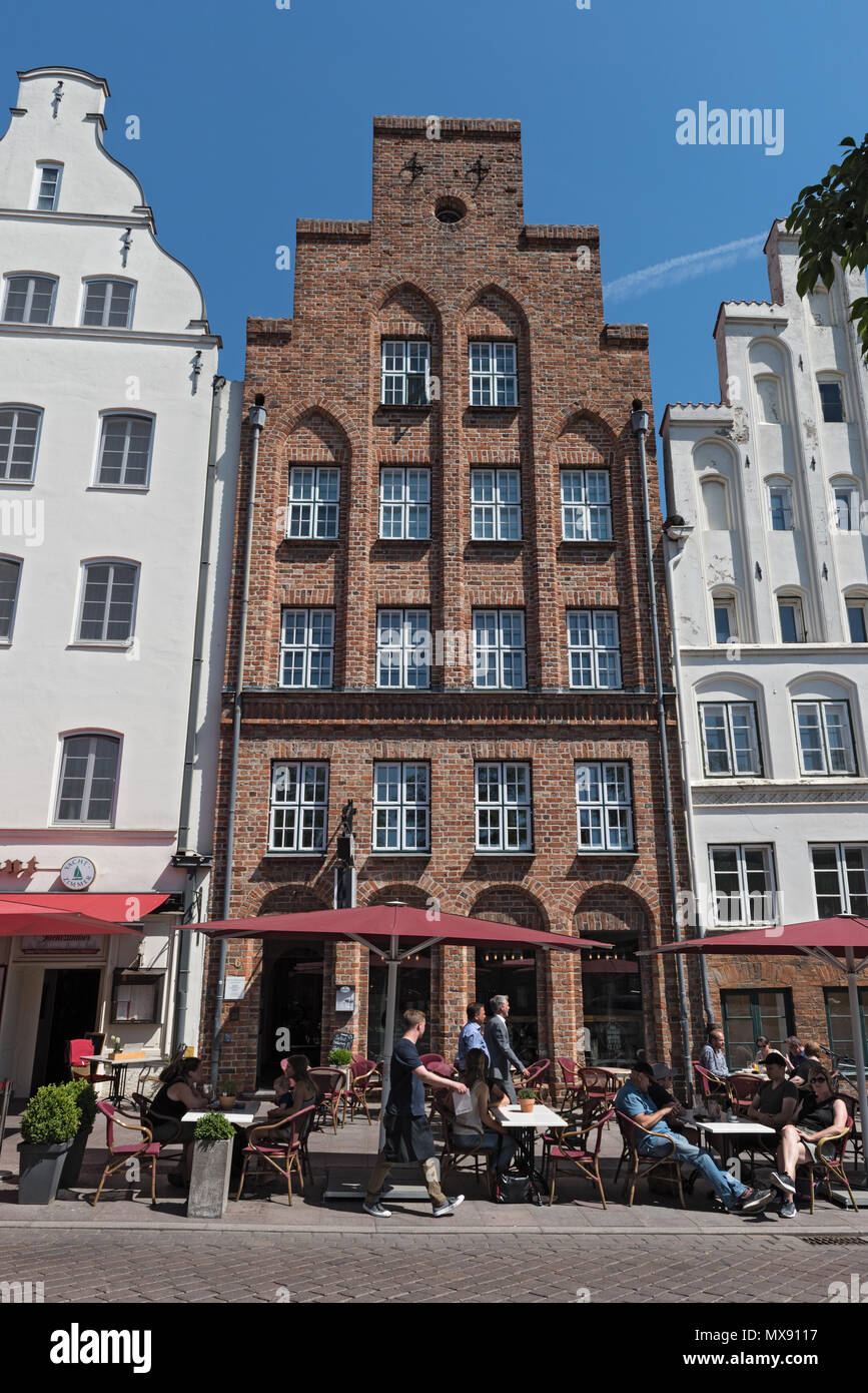 Street cafe nella parte anteriore della storica facciata in mattoni, Lubecca, Germania Foto Stock