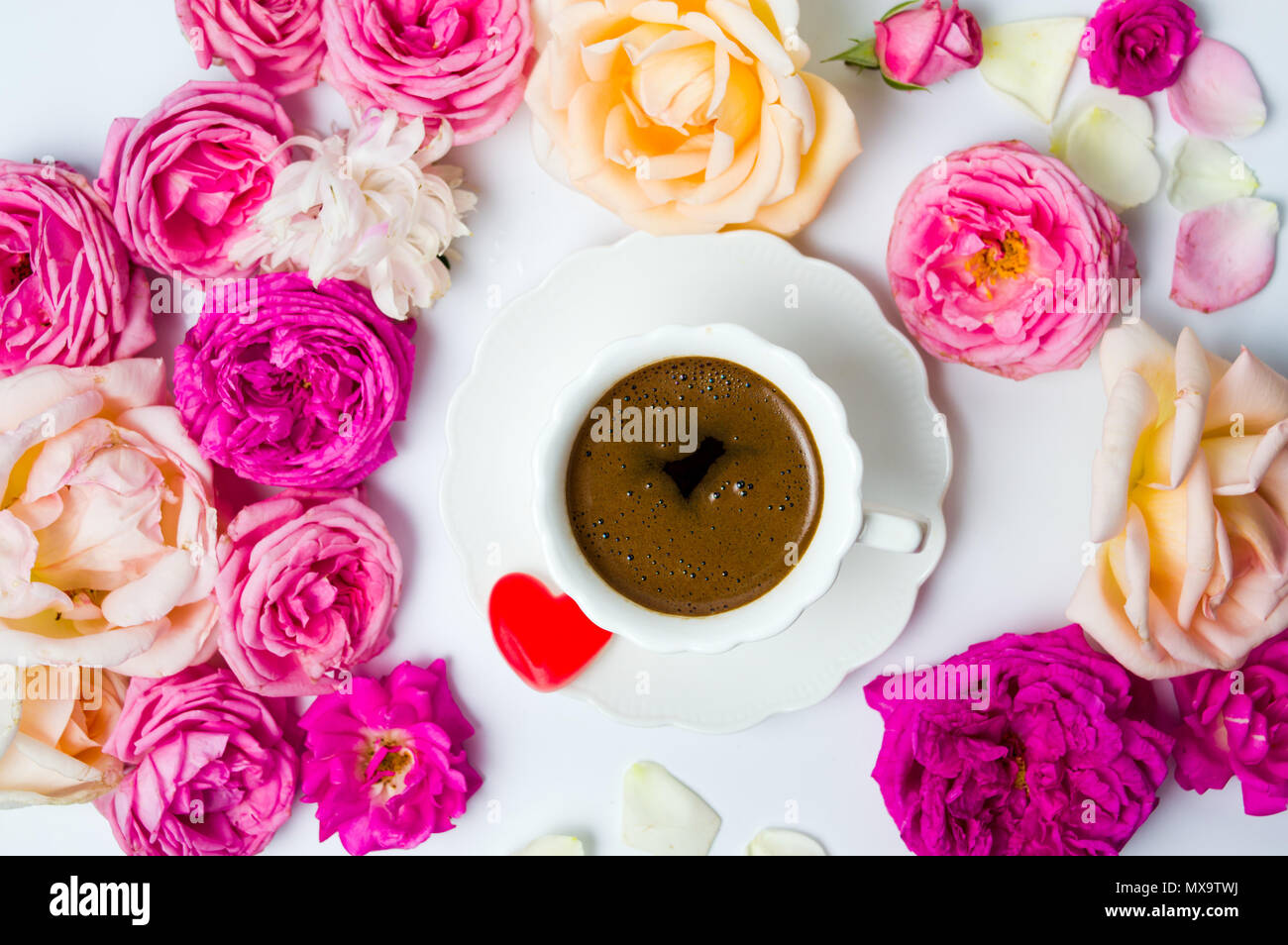 Rose colorate disposizione con una tazza di caffè Foto Stock