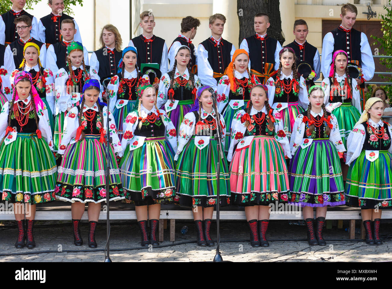 Lowicz / Polonia - maggio 31.2018: locale, regionale coro di giovani donne e uomini vestiti in costumi folcloristici. Colorato di gonne e pantaloni, camicie bianche, viv Foto Stock