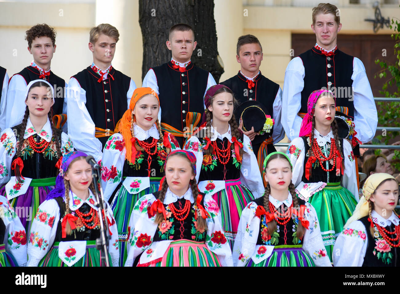 Lowicz / Polonia - maggio 31.2018: locale, regionale coro di giovani donne e uomini vestiti in costumi folcloristici. Colorato di gonne e pantaloni, camicie bianche, viv Foto Stock