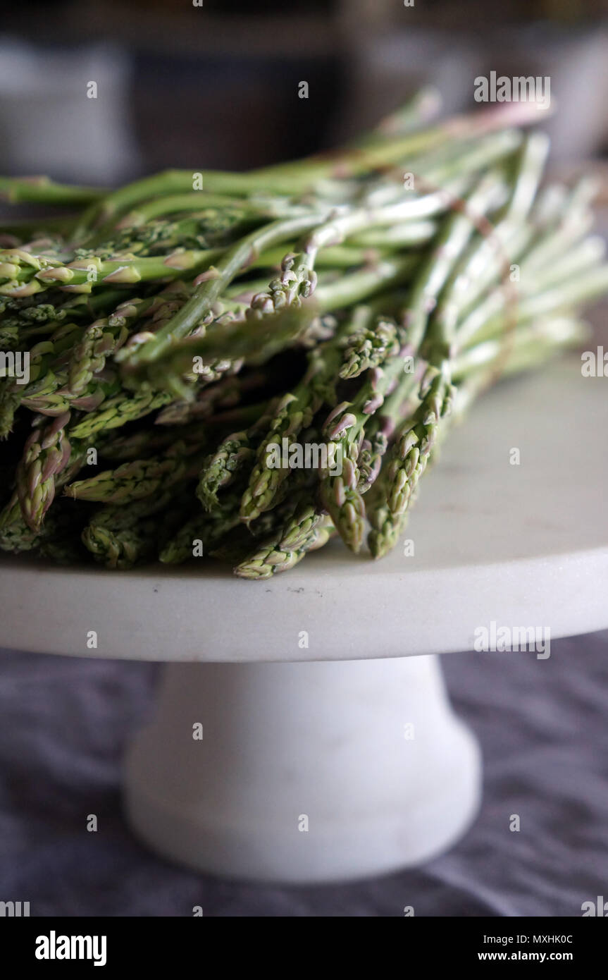 Mazzetto di asparagi su marmo round stand Foto Stock