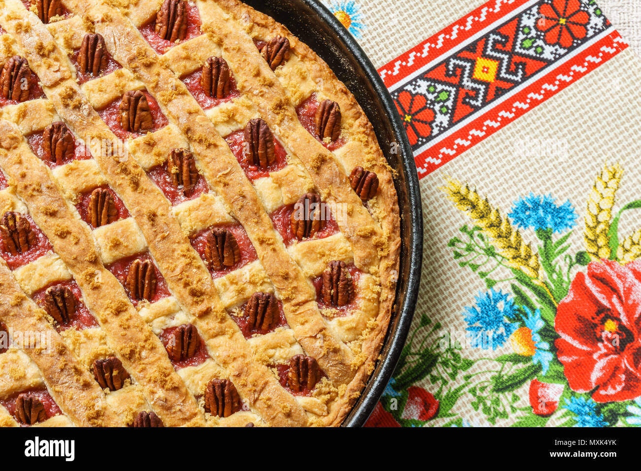 La mela intera e Torta al rabarbaro con pecan su un vassoio di nero su un tavolo. Foto Stock