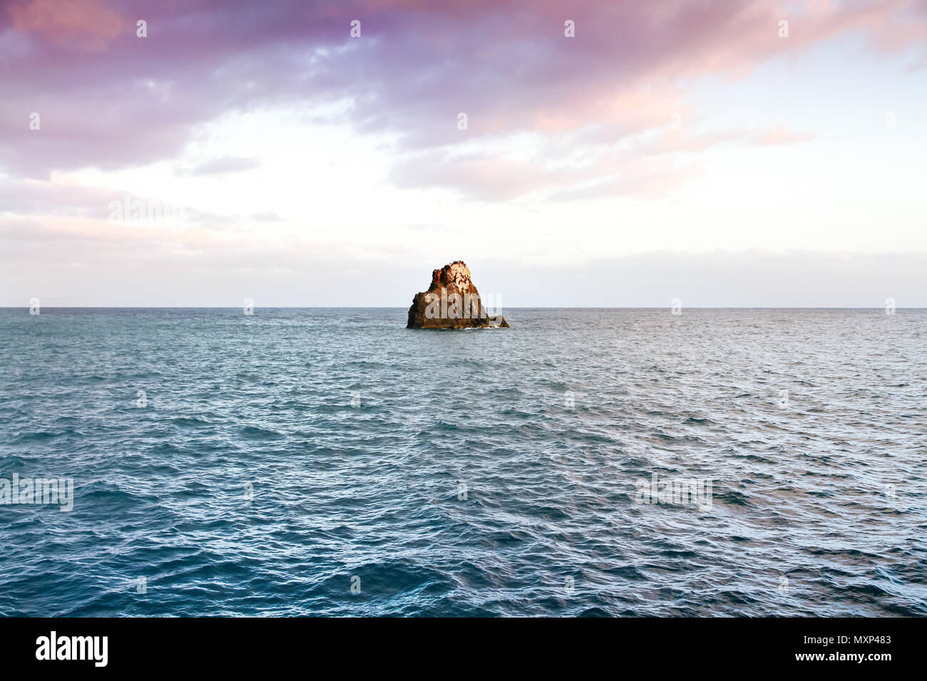 Piccola isola o isolotto (Ilheu do Gorgulho), una piccola scogliera di roccia circondato dalle acque blu dell'Oceano Atlantico a Funchal, Madeira, Portogallo assortiti Foto Stock