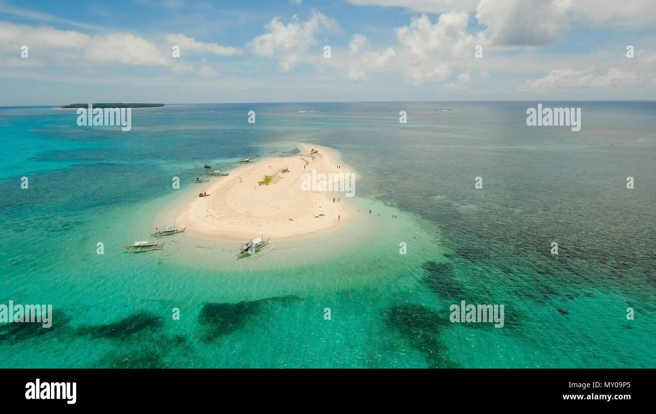 Vista aerea di bella sabbia isola tropicale con spiaggia di sabbia bianca e turisti. La sabbia bianca isola. Seascape: oceano e bellissima spiaggia paradiso. Filippine, Siargao. Concetto di viaggio. Foto Stock