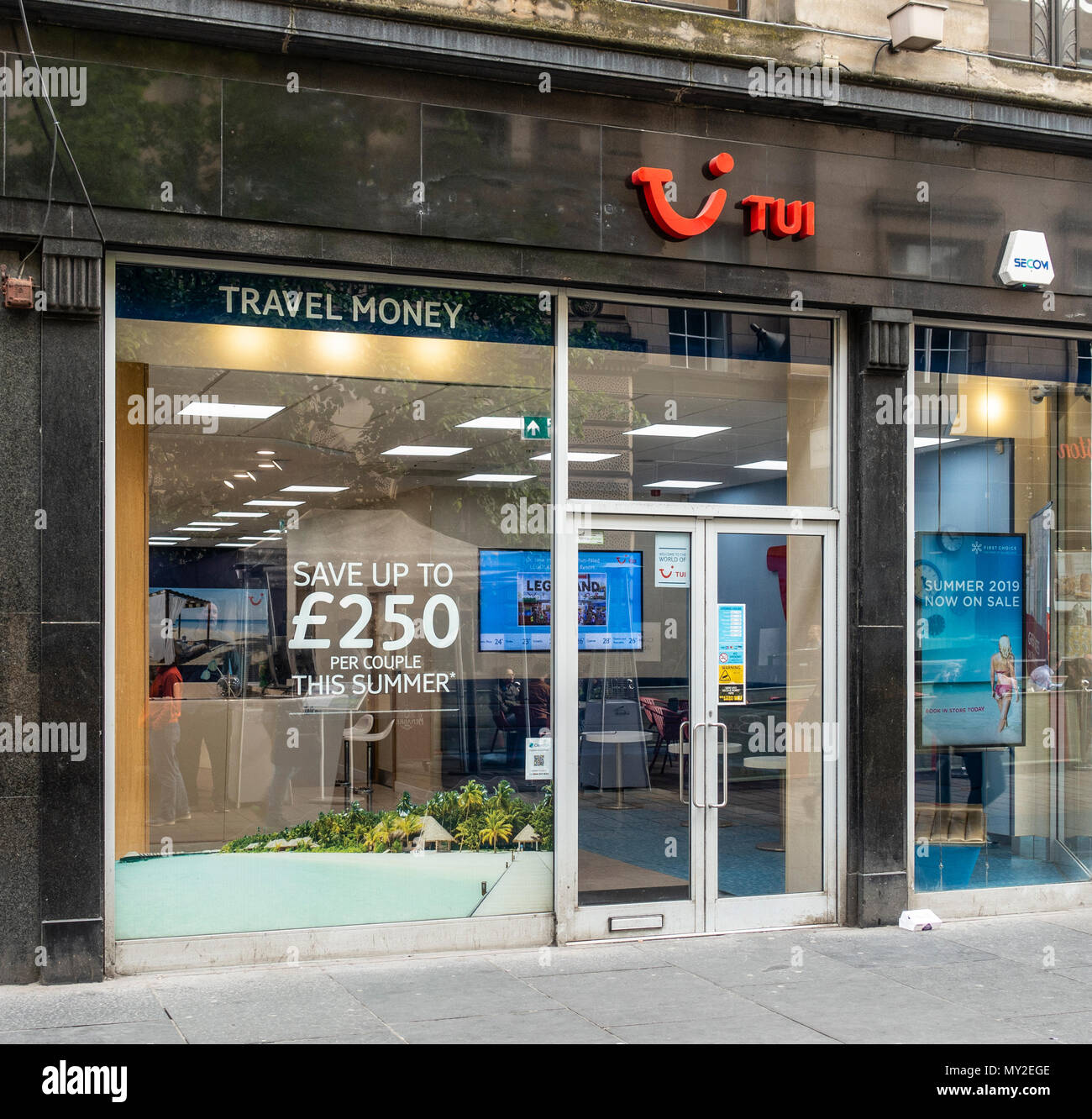 Facciata e ingresso alla Tui travel agency in Gordon Street, Central Glasgow, Scotland, Regno Unito. Porta di ingresso, poster, pubblicità, vendita d'estate. Foto Stock