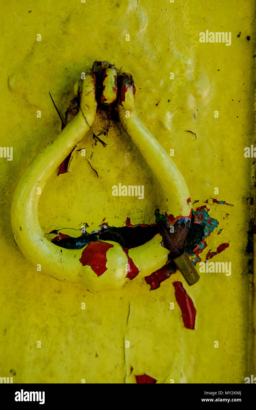 Giallo e Rosso vernice scrostata su una vecchia porta di legno Foto Stock