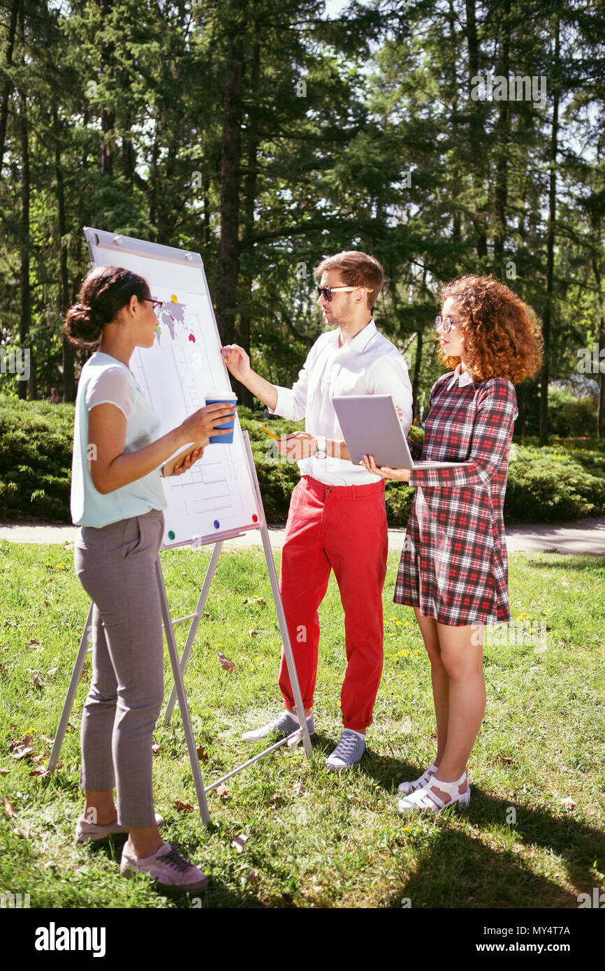 Concentrato studente maschio parlando il suo progetto Foto Stock