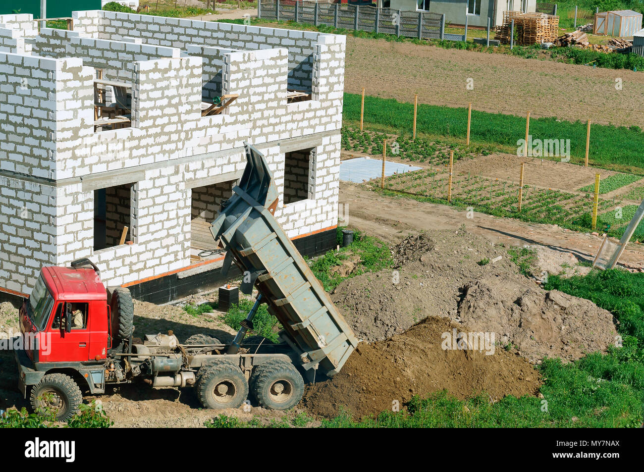 L'escavatore dissodare il terreno, l'escavatore funziona come una benna, macchine per movimento terra nel caso Foto Stock