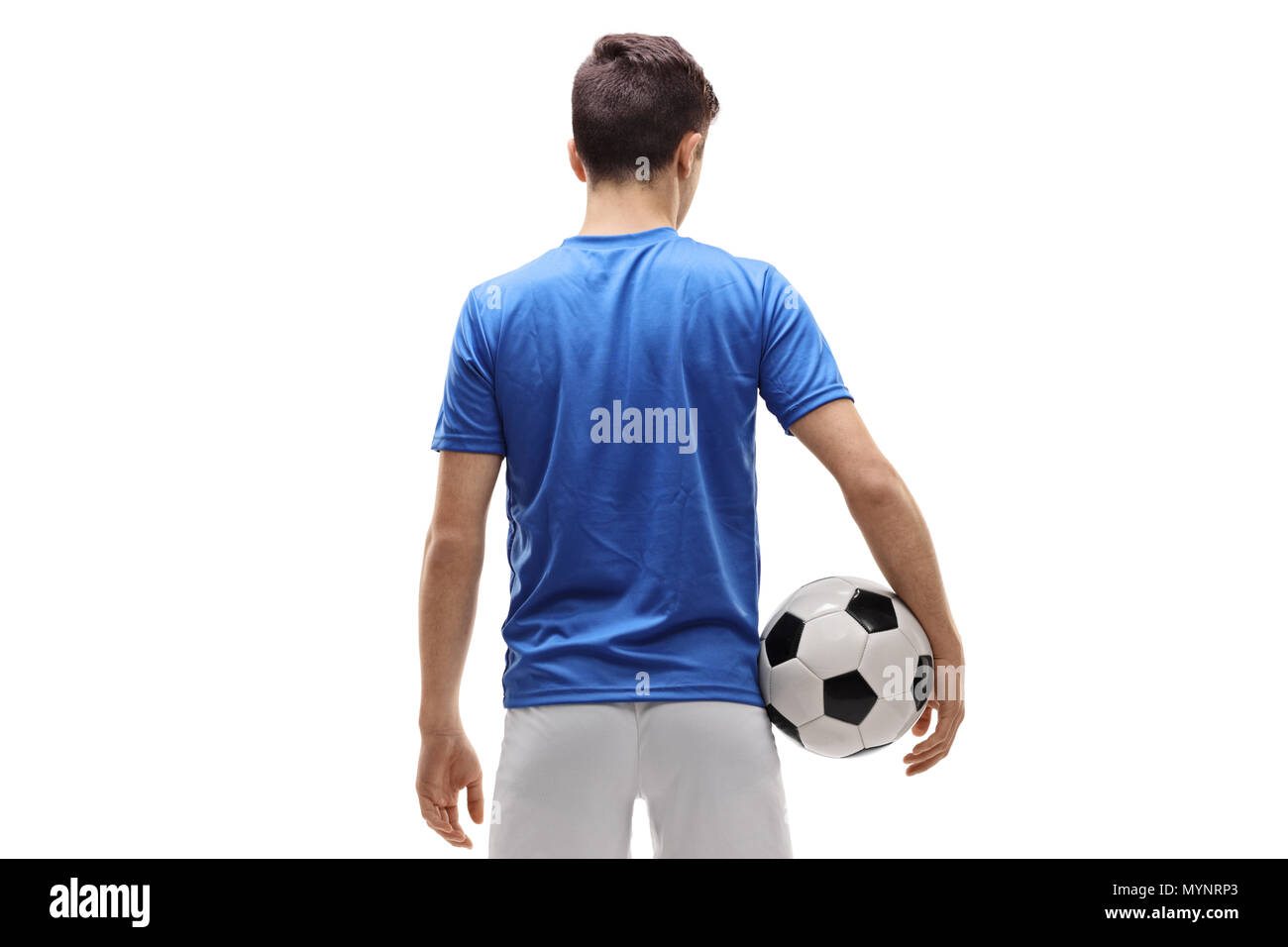 Vista posteriore del colpo di un adolescente giocatore di calcio tenendo un calcio isolati su sfondo bianco Foto Stock