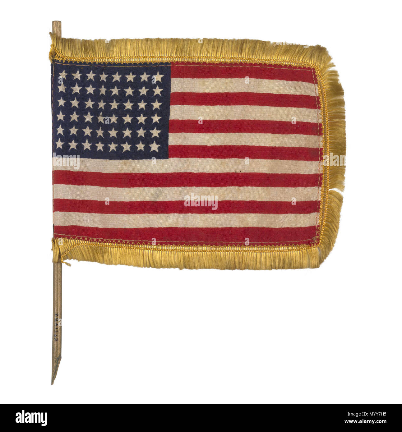 . Inglese: bandiera nazionale degli Stati Uniti (1912-1959) USA bandiera nazionale, modello 1912-59, utilizzato come una tabella bandiera. Esso è realizzato in tessuto sintetico, macchina cucito con il disegno stampato sul tessuto. Una frangia di colore giallo è attaccata al bordo e la bandiera è montato su un bastone che è stato rotto in qualche momento nel passato. Questo indicatore è una delle bandiere poste su tavoli a cene di lancio per le navi da carico costruite per il ministero britannico dei Trasporti di guerra dal ferro Todd-Bath Costruzione navale Corporation, Maine nel 1942. La bandiera è stata donata con altro materiale relativo al lancio di "Ocean Forza" 1942. N Foto Stock