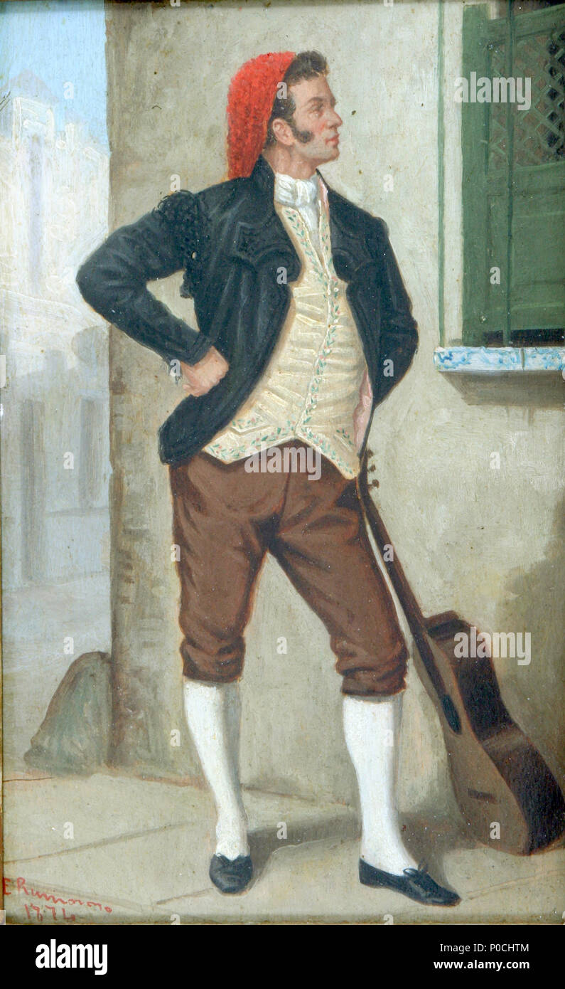 . Inglese: Un ben vestito uomo spagnolo in un cappuccio rosso orgogliosamente pone con la sua chitarra in un dipinto del 1874. Olio su pannello, 6-12/16" x 4-3/8". . 1874. Enrique rumoroso y Valdes 94 uomo spagnolo con la chitarra Foto Stock