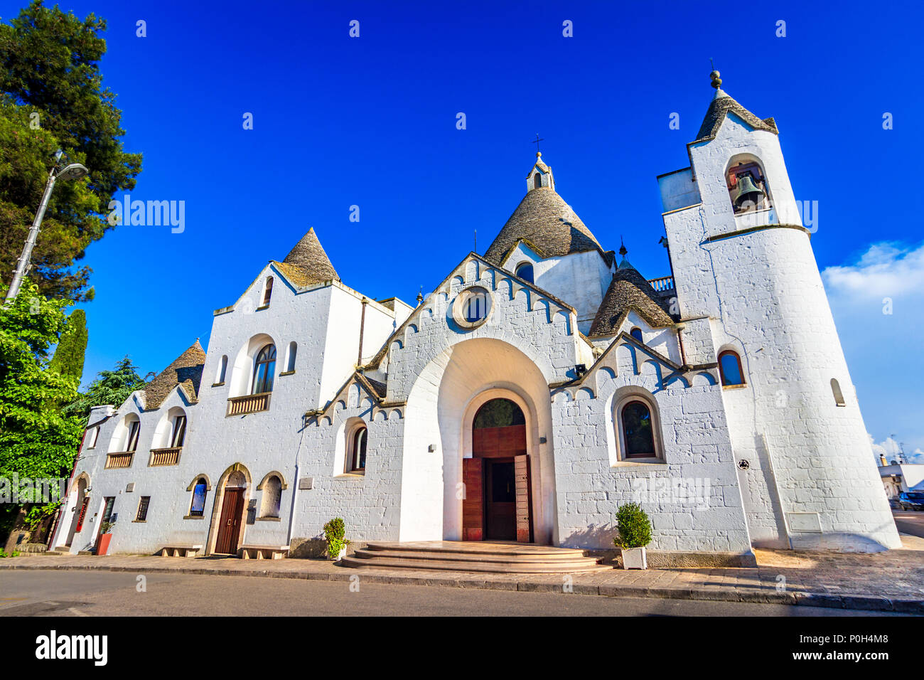 Alberobello Puglia, Italia: la chiesa di San Antonio costruito con trullo tetti conici, in una bella giornata, Puglia Foto Stock