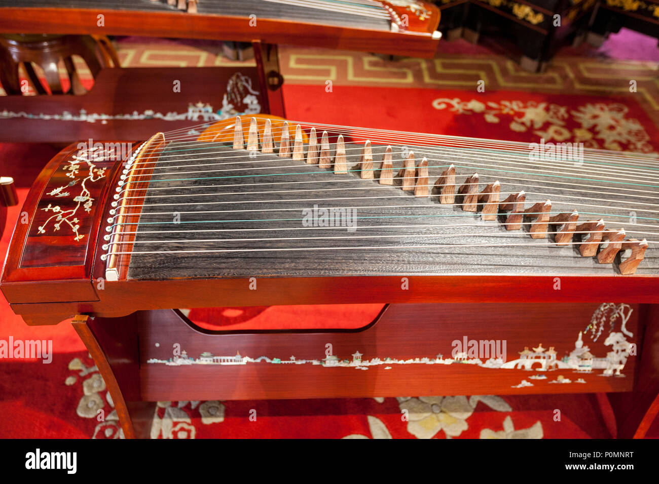 Yangzhou, Jiangsu, Cina. Guzheng, un Cinese tradizionale strumento a corda. Snello West Lake Park. Foto Stock