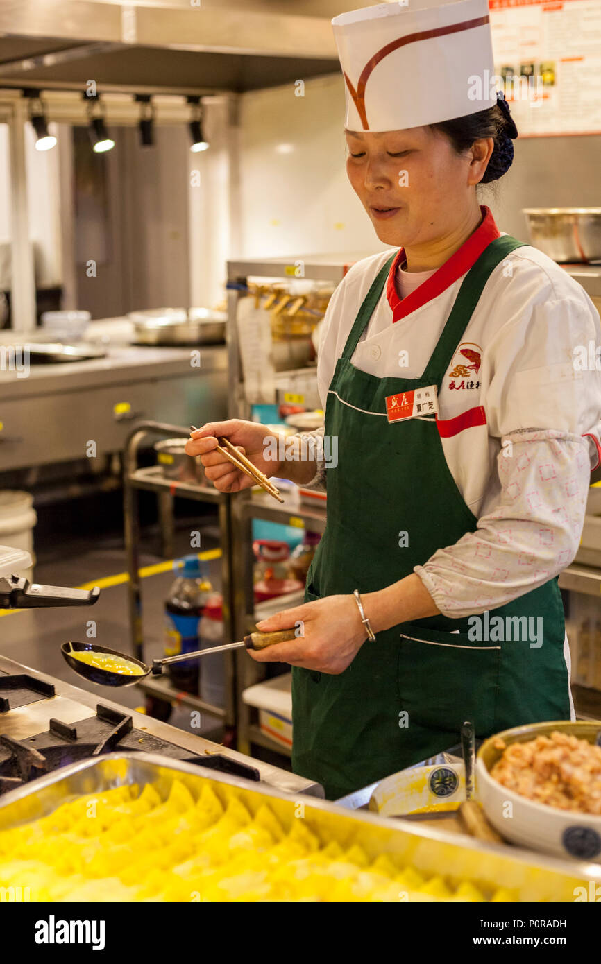 Nanjing, Jiangsu, Cina. Cuocere nel ristorante cucina rendendo uovo gnocchi con carne di maiale. Foto Stock