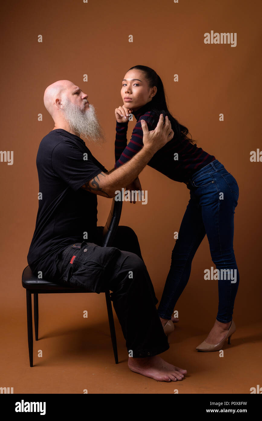 Coppia barbuto uomo calvo con giovani asiatici transgender donna Foto Stock