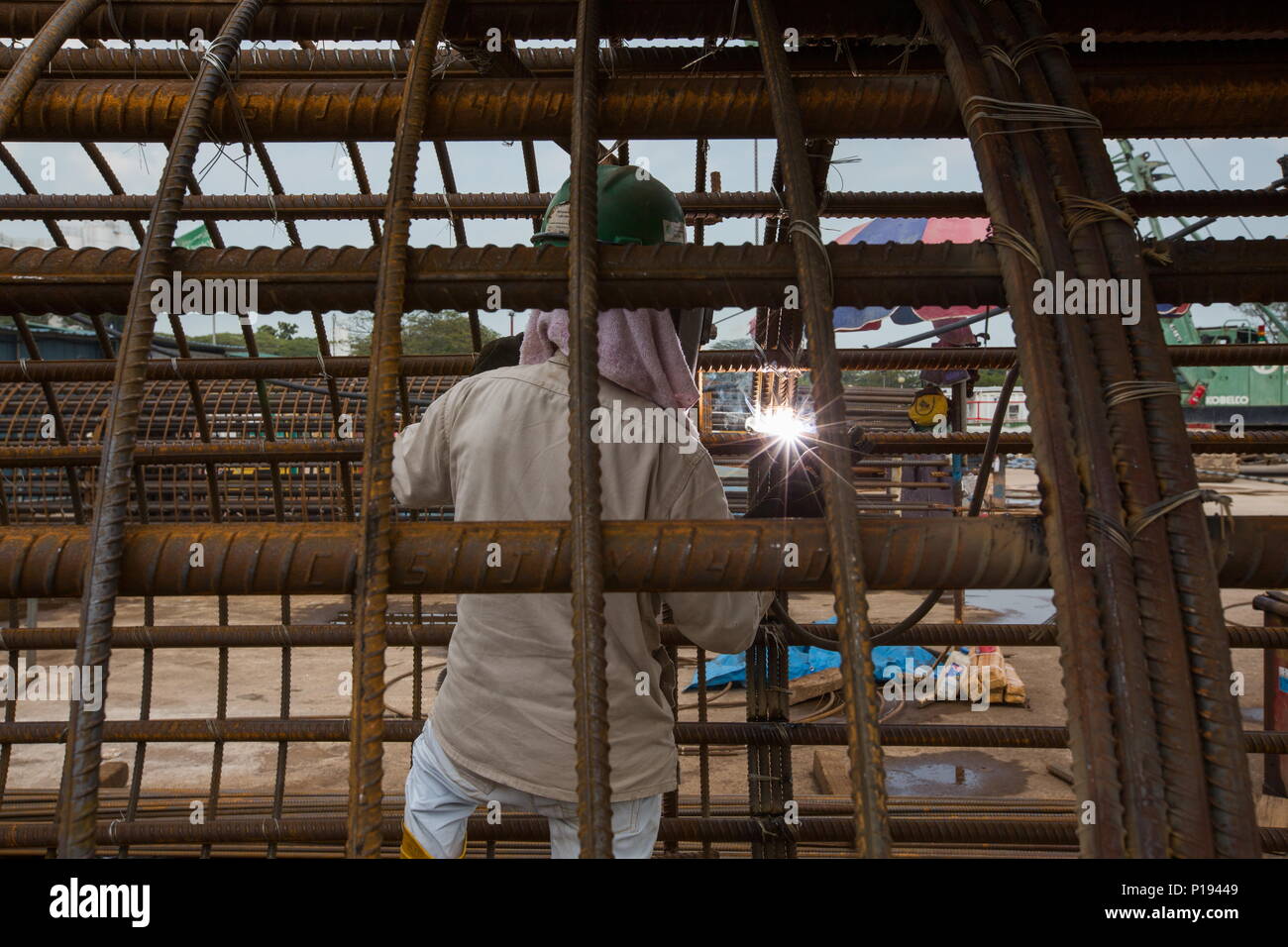 Un lavoratore di costruzione che lavora in una gabbia prefabbricata. Foto Stock