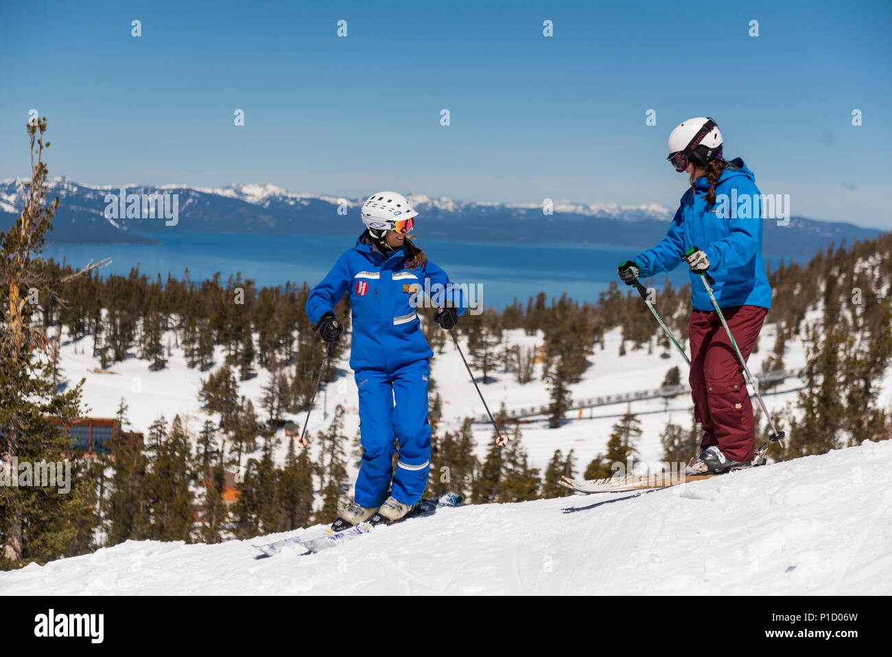 Heavenly Ski istruttore lavora con uno studente durante una lezione per principianti a valle celeste Area sciistica con il lago Tahoe in background. Foto Stock