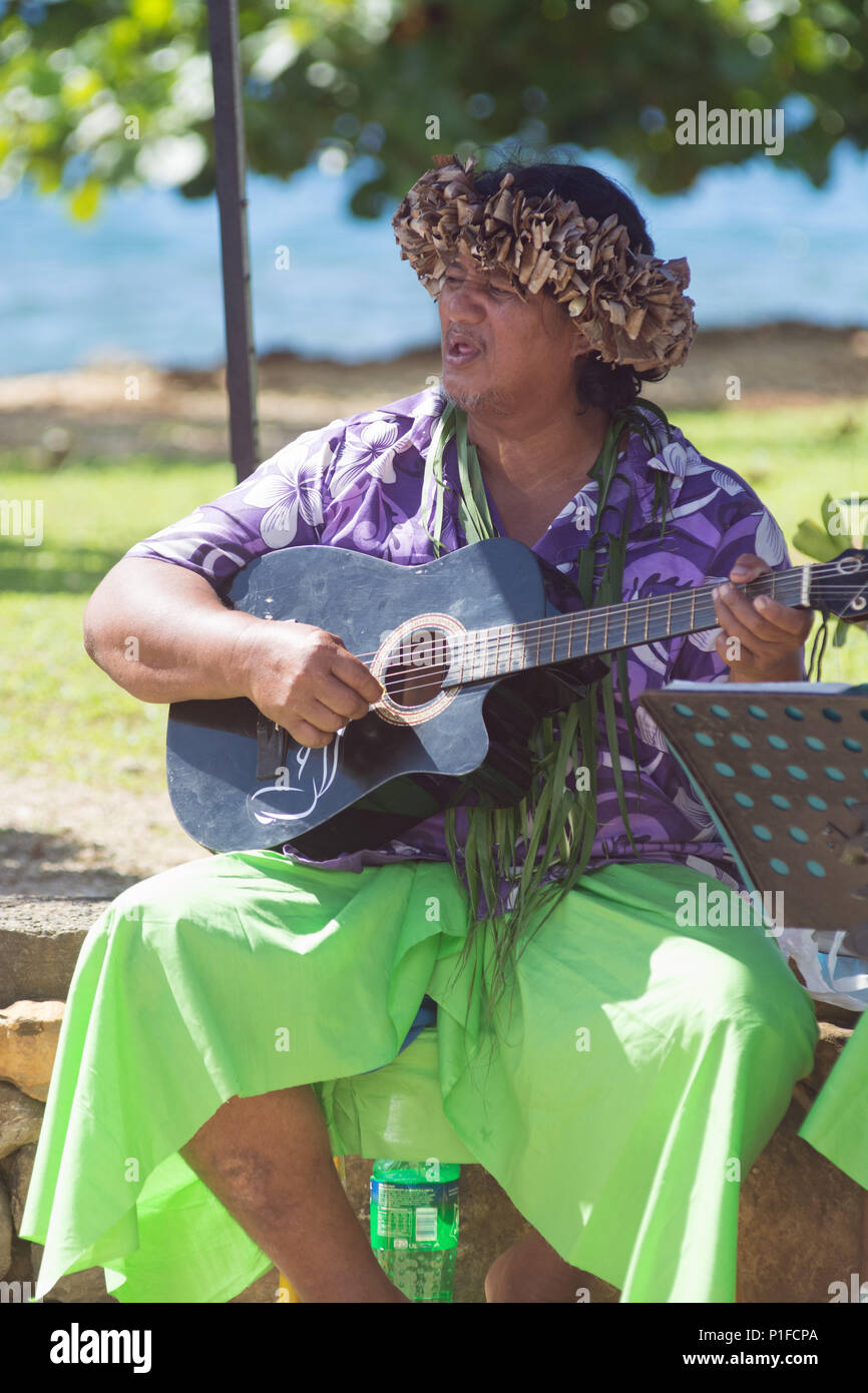 Uomo polinesiano in costume locale svolge la sua chitarra. PAUL GAUGUIN crociera a Huahine Island Foto Stock