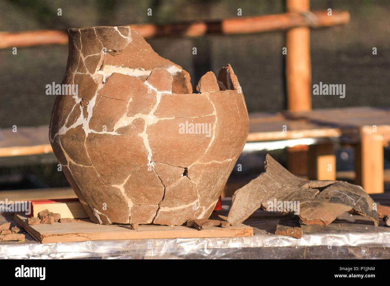 Stage di restauro di un preistorico vaso in ceramica all'esterno, su un sito neolitjic nei Balcani Foto Stock