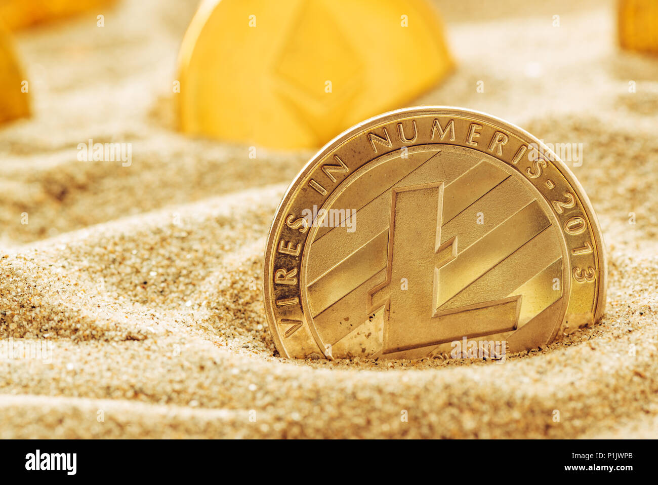 Argento Litecoin coin in sabbia, immagine concettuale per oggetti smarriti e ritrovati cryptocurrency preziose monete che sono in piedi la prova di tempo. Foto Stock