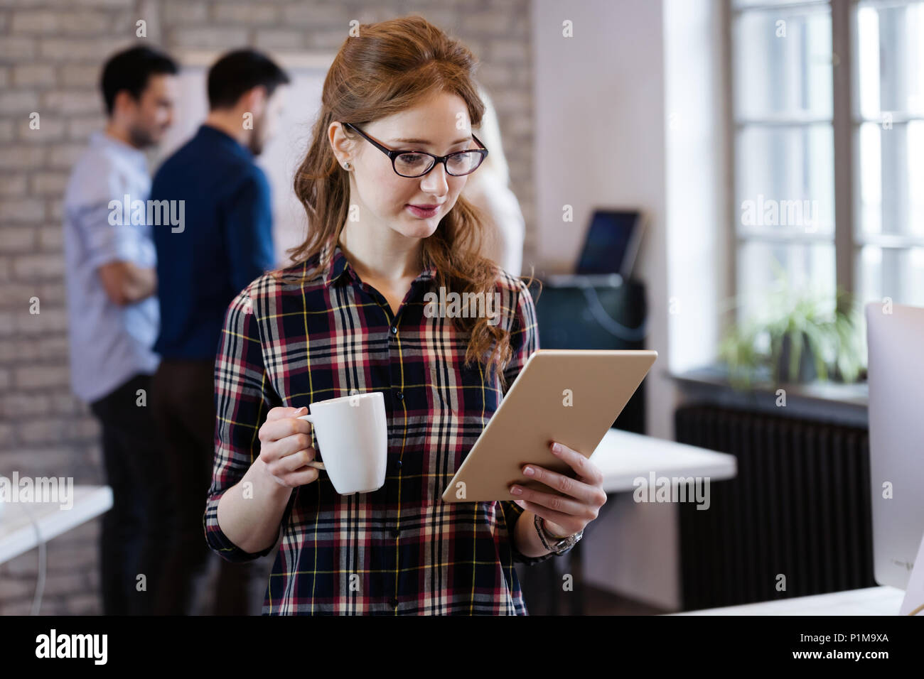 Giovane architetto attraente lavorando in ufficio moderno Foto Stock