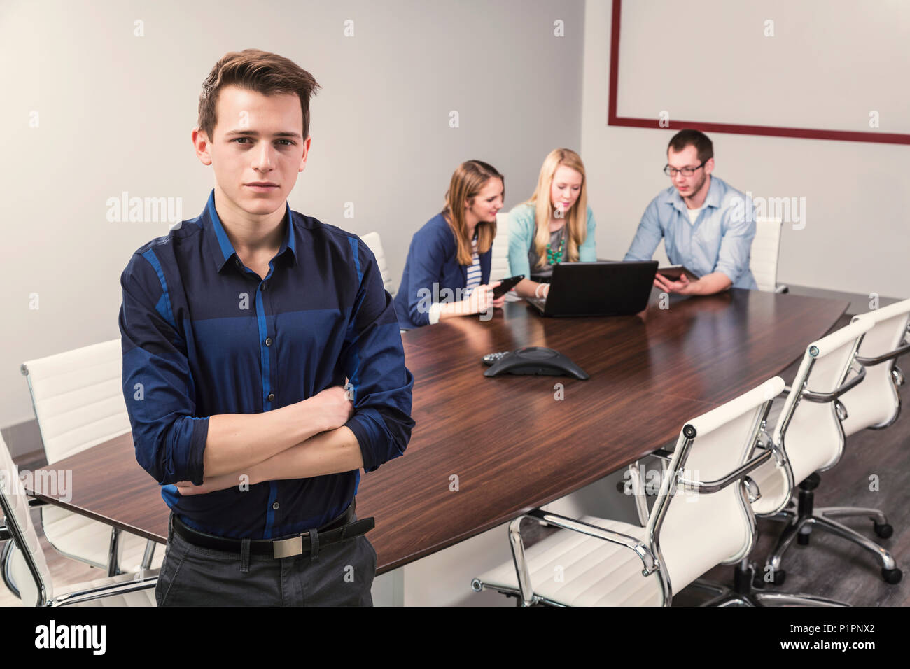 Millenaria di giovani professionisti che lavorano insieme in una sala conferenze in un high tech moderno business; Sherwood Park, Alberta, Canada Foto Stock