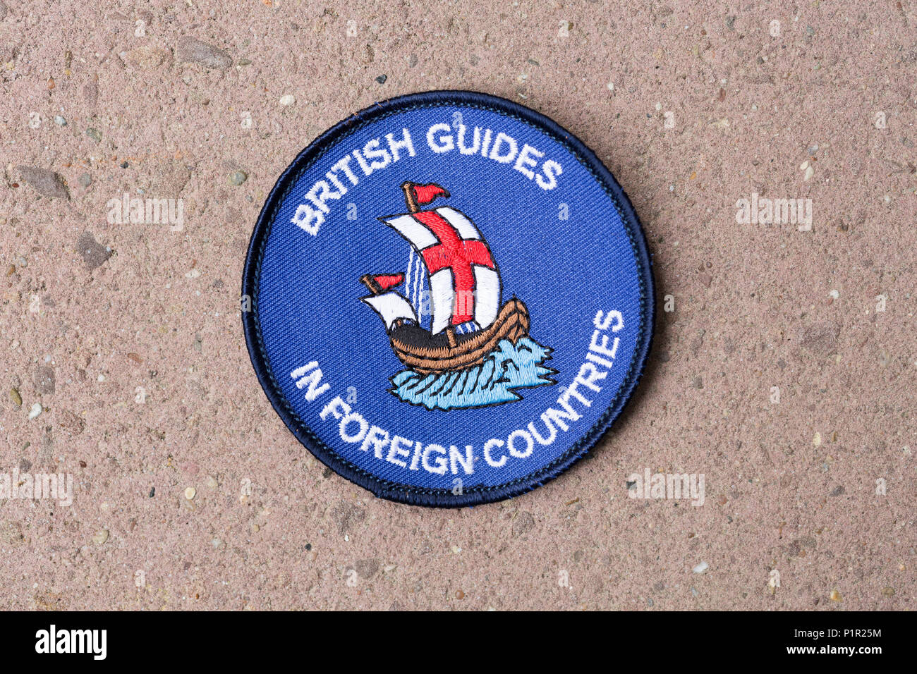Guida ragazza / Brownie celebra badge guide britannico in paesi stranieri / oltremare Foto Stock