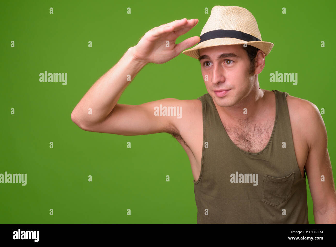 Giovane turista uomo contro lo sfondo di colore verde Foto Stock