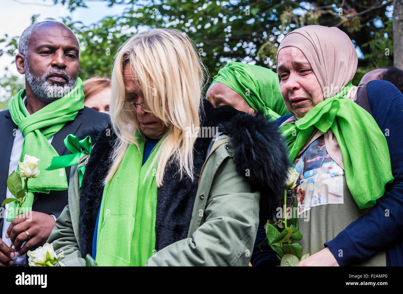 Amici e familiari a piedi verso Grenfell Tower, per contrassegnare il un anno di anniversario del fuoco, due donne piange di commozione, Londra, Inghilterra, Regno Unito, 14 giugno 2018 Foto Stock