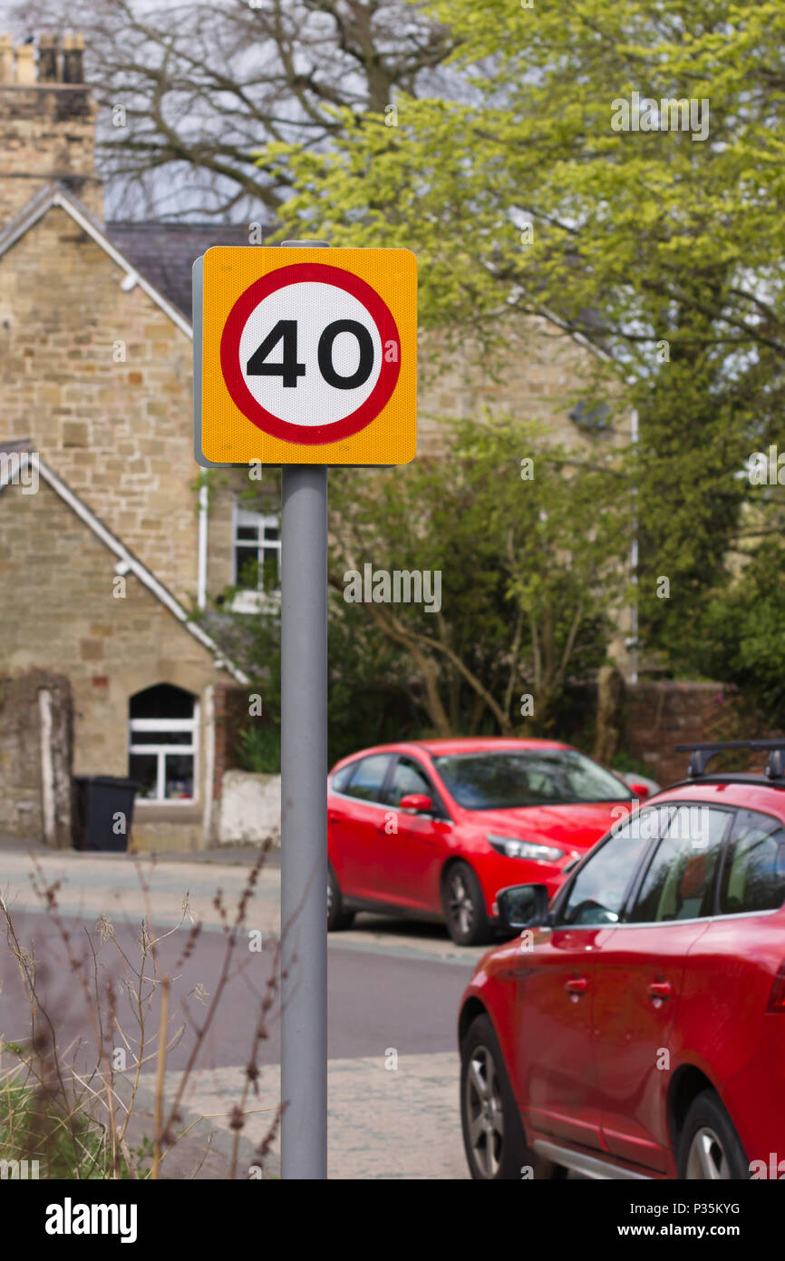 Urban 40 miglia per ora segnale di limite di velocità nel Regno Unito con defocussed traffico in background Foto Stock