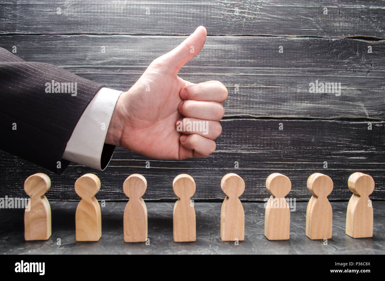 L'imprenditore il lato mostra un pollice in alto al di sopra delle figure dei lavoratori. Il concetto di omologazione di idee di business, congratulazioni per il successo del business Foto Stock