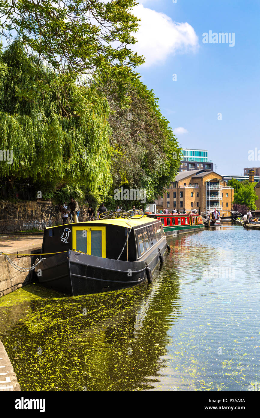 Un giallo e nero houseboat ormeggio sul Regents Canal vicino a Angel, London, Regno Unito Foto Stock