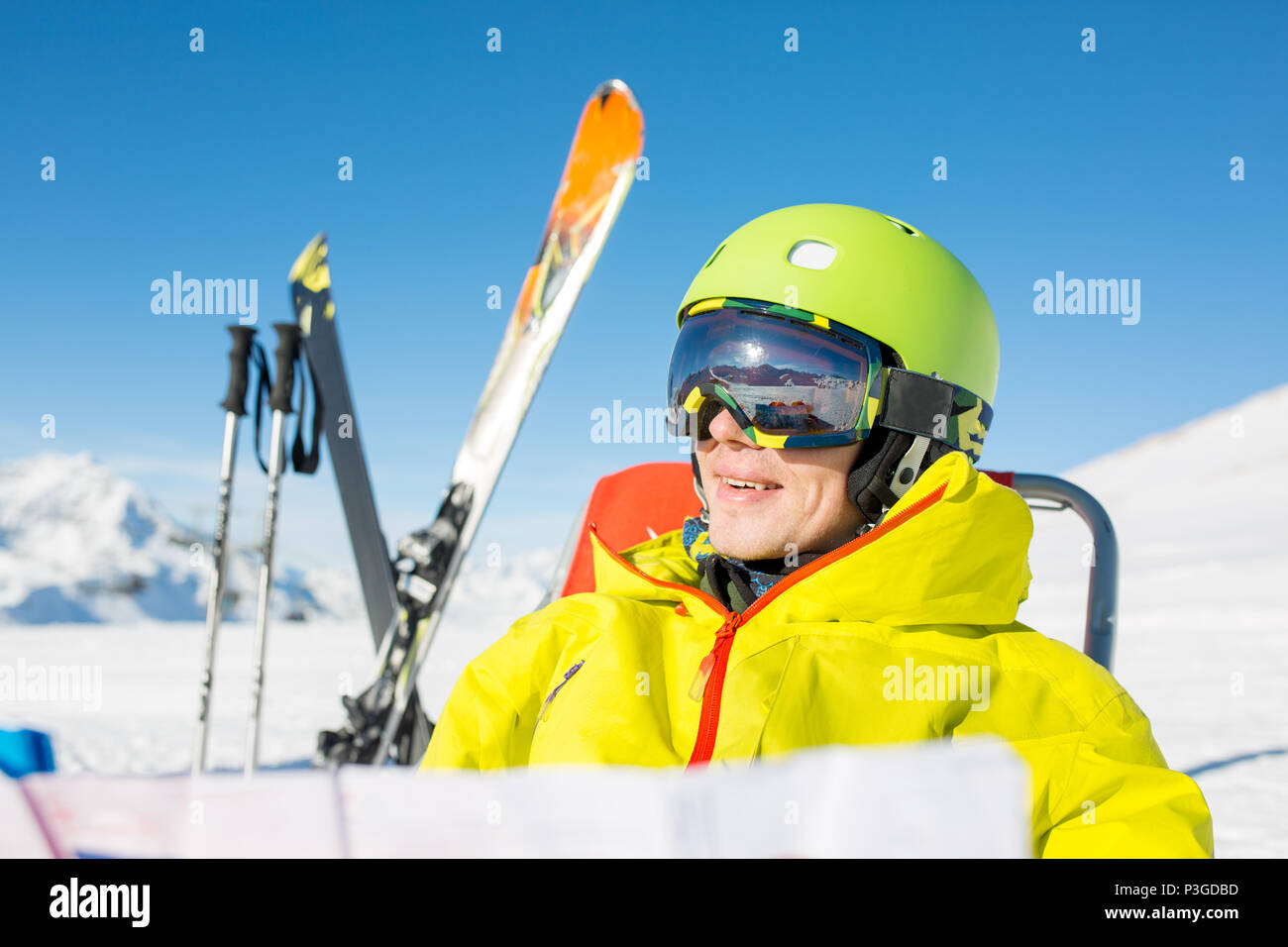 Foto di uomo sportivo nel casco seduto in poltrona Foto Stock