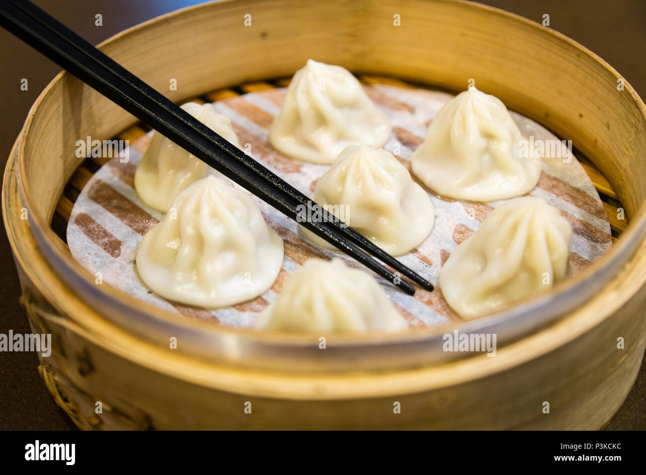 Cinese tradizionale gnocchi vaporizzato in un vaporizzatore di bambù Foto Stock