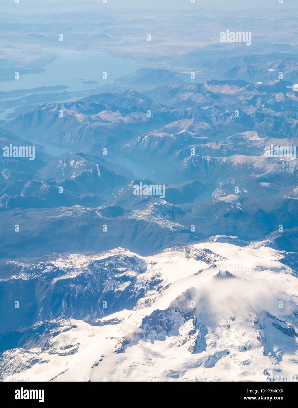 Vista dalla finestra aereo della coperta di neve montagne delle Ande con laghi e ghiacciai, Patagonia meridionale del campo di ghiaccio, Patagonia, Cile, Sud America Foto Stock