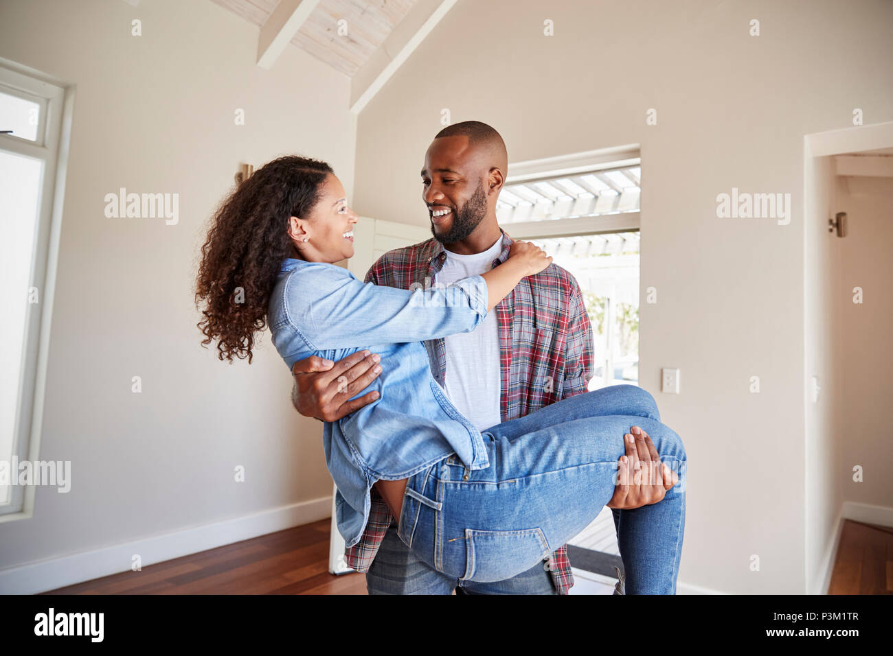 Uomo Donna portante al di sopra della soglia della porta nella nuova casa Foto Stock