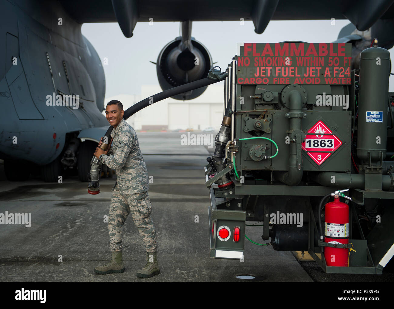 Airman Seth Roy, 628th disponibilità logistiche squadrone di distribuzione di carburanti operatore, sorrisi mentre si tiene un flessibile carburante Luglio 18, 2016 a base comune, Charleston S.C. Lo scorso anno oltre 50 avieri del 628th combustibili LRS volo fornito la base con più di 36 milioni di galloni di carburante per le missioni in tutta la base. (U.S. Air Force foto/Staff Sgt. Jared Trimarchi) Foto Stock